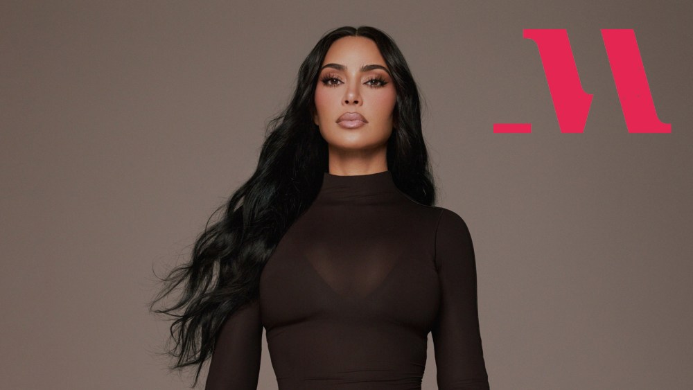 kim kardashian in a promo photo for her new masterclass course, with the platform's logo overlaid on the image