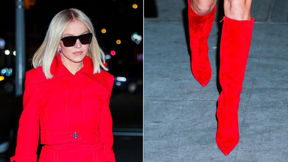 Sydney Sweeney in a monochrome red look punctuated by Magda Butrym red suede knee-high boots while out in New York City promoting "The Housemaid" on Monday.