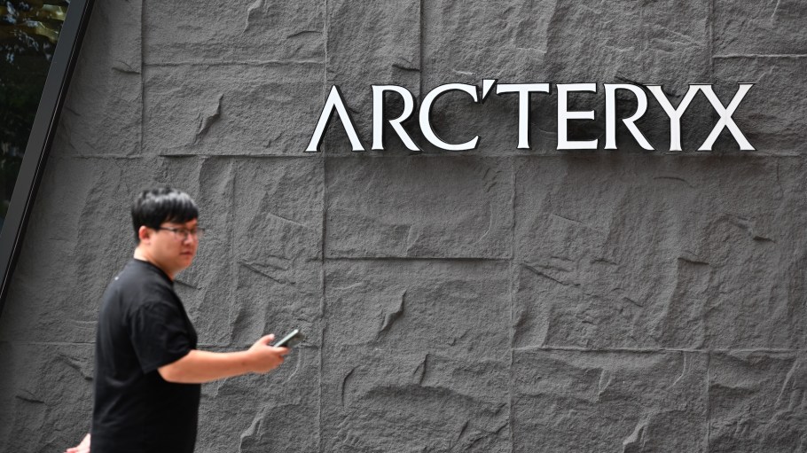 A citizen walks by the logo of Arc'teryx, owned by Finland-based Amer Sports and partly controlled by China's Anta Group, on September 22, 2025 in Nanjing, Jiangsu Province of China.