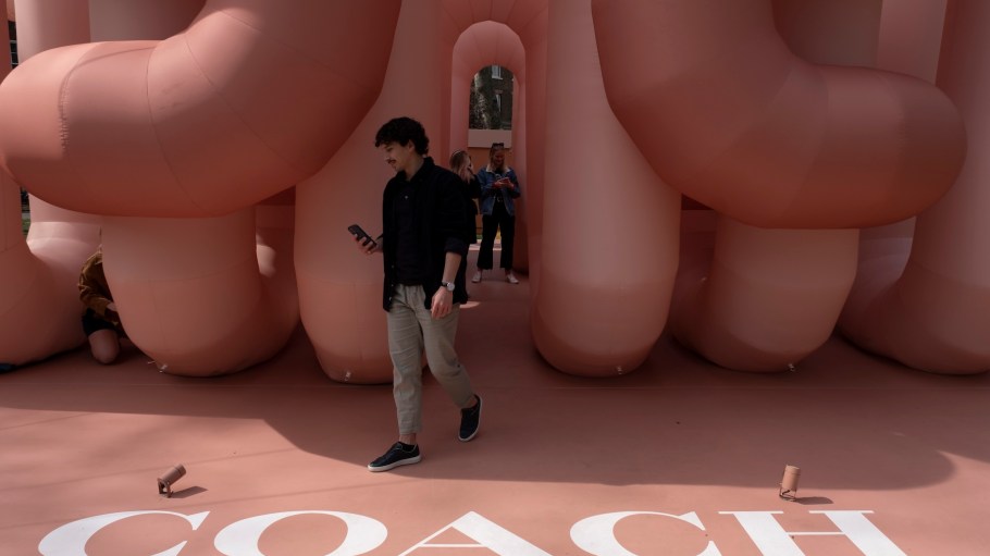 Luxury accessory brand Coach installed inflatable installation in collaboration with artist Cyril Lancelin in Soho Square on 10th April 2022 in London, United Kingdom. Inspired by the house’s quilted shoulder bag, the Pillow Tabby, the soft pink structure creates an immersive space for people to walk through.