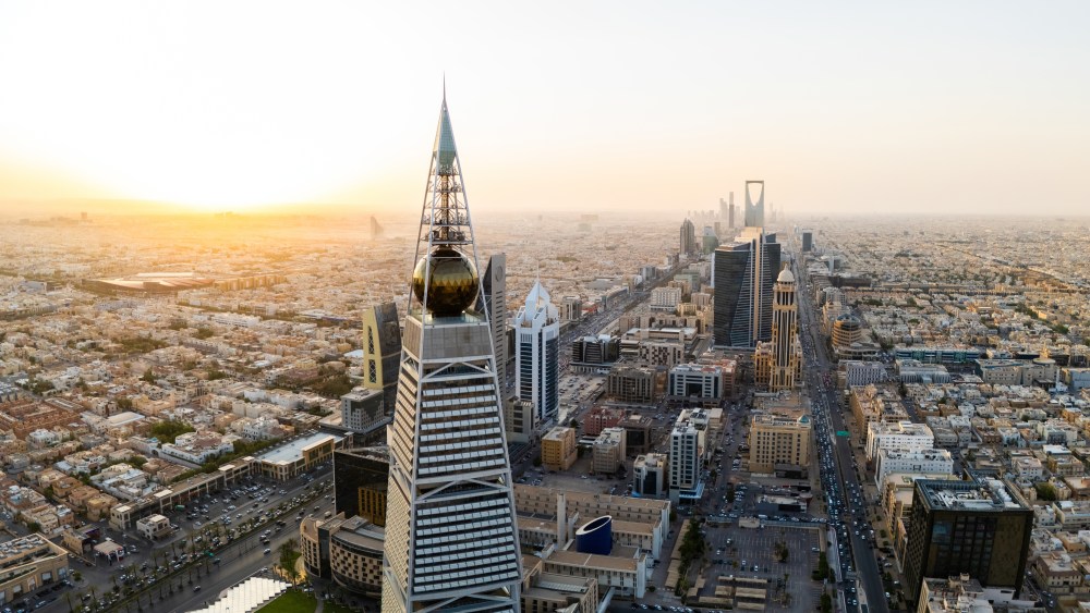 Al Faisaliah Tower pyramid-shaped commercial skyscraper. Riyadh. Drone shot flying. Sunset. Evening. Al Faisaliah Tower is a striking pyramid-shaped skyscraper in the heart of Riyadh, Saudi Arabia. Its unique design, which is a graceful pyramid with a distinctive golden glass sphere at the top, sets it apart from the rest of Riyadh's skyline. High-quality photo