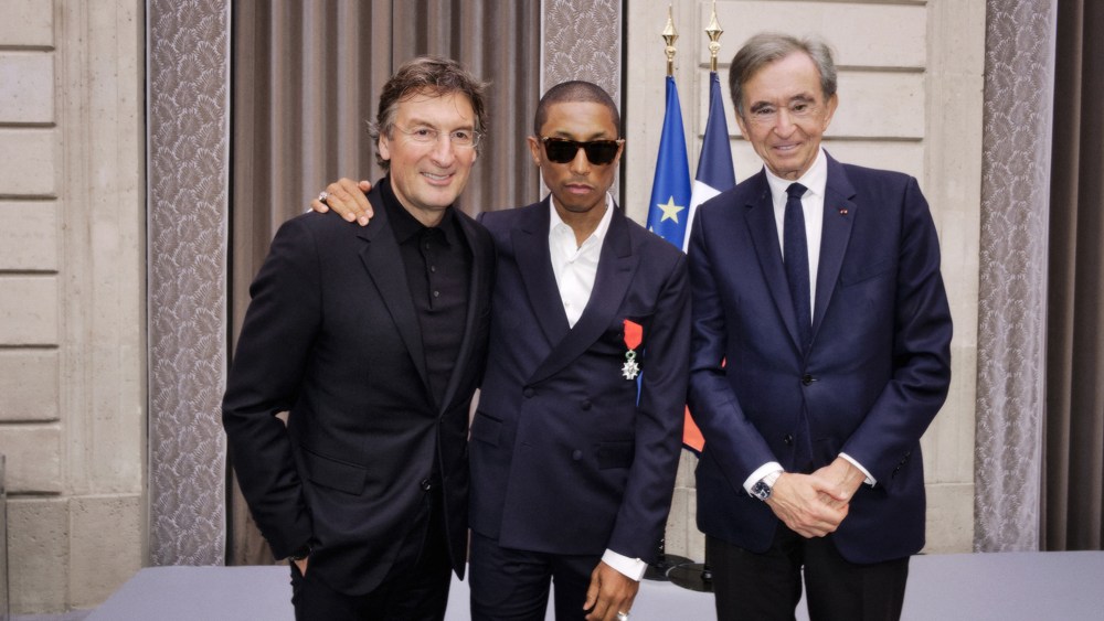 Pietro Beccari, Pharrell Williams and Bernard Arnault at a ceremony in Paris that made Williams a Knight of the Legion of Honor.