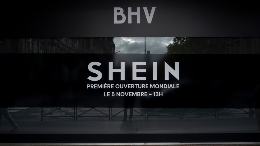 A close-up of a promotional image shows the BHV logo, the SHEIN logo, and text announcing the upcoming opening at BHV Marais. The Chinese online retail giant opens its first permanent store within the BHV department store on November 5. In Paris, France, on November 3, 2025. (Photo by Samuel Boivin/NurPhoto via Getty Images)