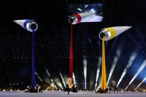 Giant paint tubes are seen as performers dance during the opening ceremony of the Milano Cortina 2026 Winter Olympics at San Siro Stadium.