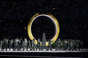 An actor performs inside rings during the opening ceremony of the Milano Cortina 2026 Winter Olympics.