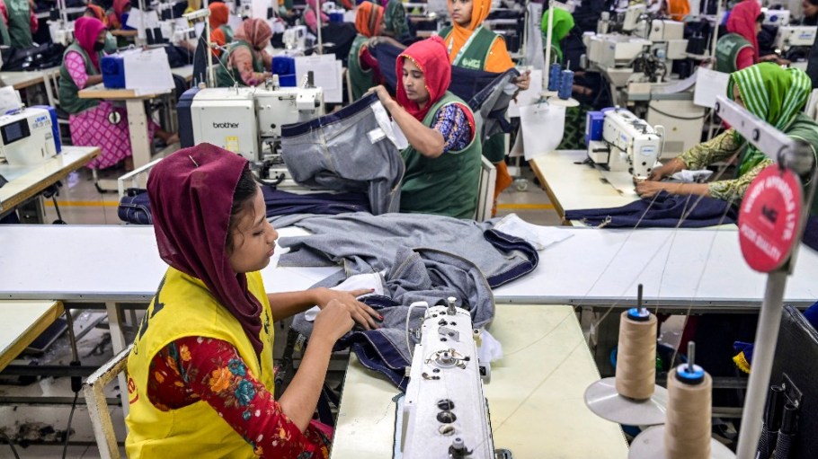 Garment workers tailor clothes at their sewing stations in a garment factory in Tongi, on the outskirts of Dhaka, Bangladesh.