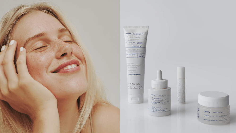 woman smiling with her eyes closed and her hand on her face; a four-piece skin care set from korres over a light gray background