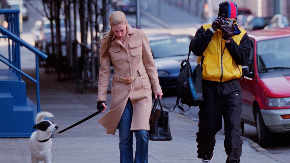 John F. Kennedy Junior and wife Carolyn Bessette and dog take a stroll in Tribeca. John takes photos with a Leica camera of the photographers. (Photo by Lawrence Schwartzwald/Sygma via Getty Images)