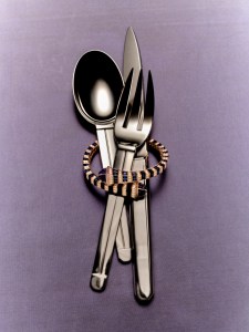 Marli New York Cleo sculpt bracelet with diamonds and blue sapphires set in 18-karat rose gold; Puiforcat Guethary stainless steel flatware, available at Jung Lee.