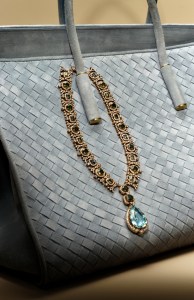 Sabyasachi diamond, sapphire and apatite necklace in 18-karat gold with a pear-shaped aquamarine and diamond pendant; Bottega Veneta suede Barbara tote.