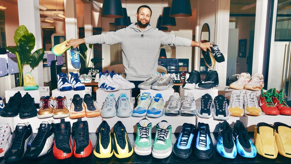 Stephen Curry posing with his sneakers.
