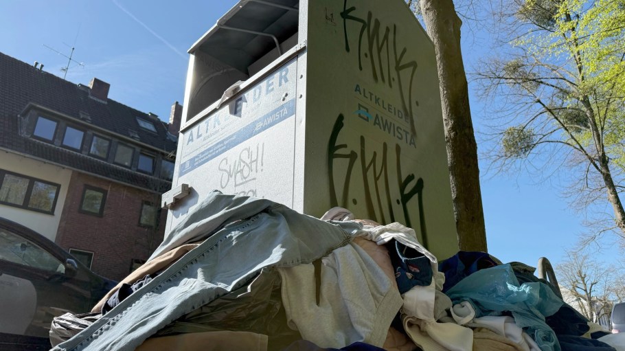 07 April 2026, North Rhine-Westphalia, Duesseldorf: Clothing lies in front of an overfilled used clothing container belonging to the municipal waste disposal company Awista. There are fewer and fewer used clothing containers in Germany, as the business with textiles is hardly worthwhile. Photo: Wolf von Dewitz/dpa (Photo by Wolf von Dewitz/picture alliance via Getty Images)