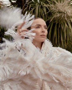 Alaïa cotton coat with embroidered silk fringes and patent calfskin leather sandals; Bulgari 18-karat yellow gold Vimini earrings.