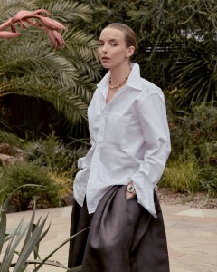 Thom Browne cotton shirt; Khaite silk skirt; The Finest Stack 14-karat yellow gold earrings; Christina Caruso 14-karat yellow gold-plated brass Love Knot necklace; Chopard 18-karat rose gold L'Heure du Diamant timepiece with a malachite dial and diamonds.