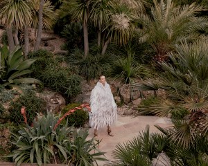 Alaïa cotton coat with embroidered silk fringes and patent calfskin leather sandals; Bulgari 18-karat yellow gold Vimini earrings.