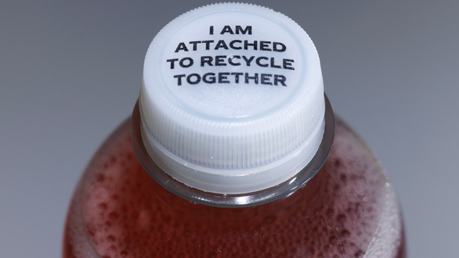 LONDON, ENGLAND - AUGUST 21: In this photo illustration, a bottle with its 'tethered cap' on August 21, 2024 in London, England. An EU-wide mandate, implemented earlier this year, is aimed at reducing plastic waste by ensuring the new 'tethered caps' stay attached to bottles, and are therefore more likely to be recycled together. Despite Britain leaving the EU most bottle manufacturers don't produce different bottles for each separate market, so despite not being mandated in the UK, the products have also affected the British consumer. (Photo by Dan Kitwood/Getty Images)