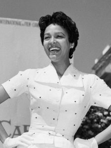 (Original Caption) 5/13/1955-Cannes, France- Actress Dorothy Dandridge throws out her hip in the sexy pose used in silhouette on ad posters for her movie "Carmen Jones." Miss Dandridge struck the silhouette stance before a billboard at Cannes, where she's attending the International Film Festival. In shadow and in substance, Dorothy's definitely a knockout.