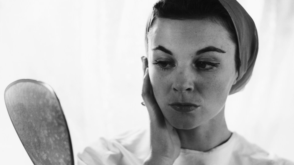 A young woman checks her make up in a handheld mirror, circa 1955. (Photo by Lipton-Bliss/Frederic Lewis/Hulton Archive/Getty Images)