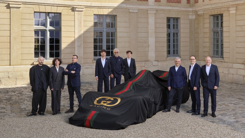 Gucci, Kering and Formula 1 officials pose for the unveiling of a partnership.
