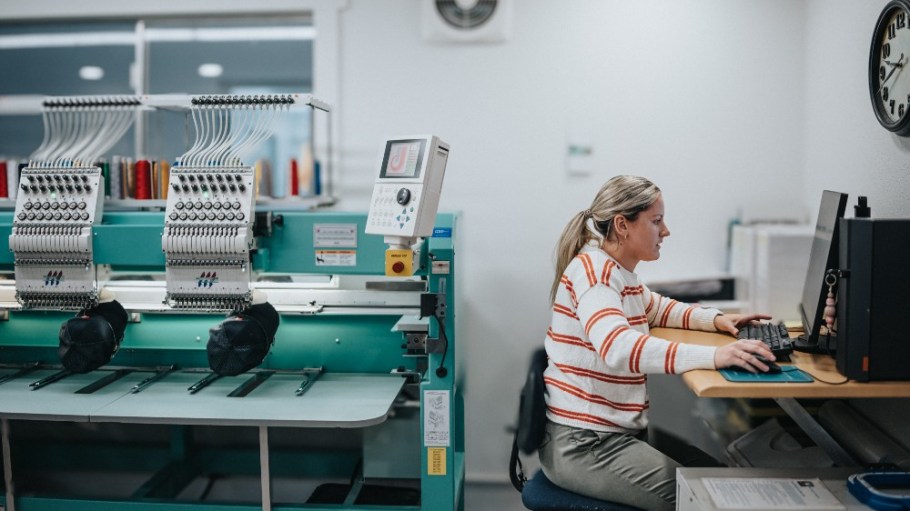 A worker operates embroidery machines.