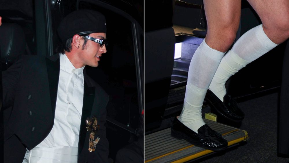 Hudson Williams at the GQ Met Gala after party in a pair of glossy ruched black loafers and semi-sheer knee-high white socks.