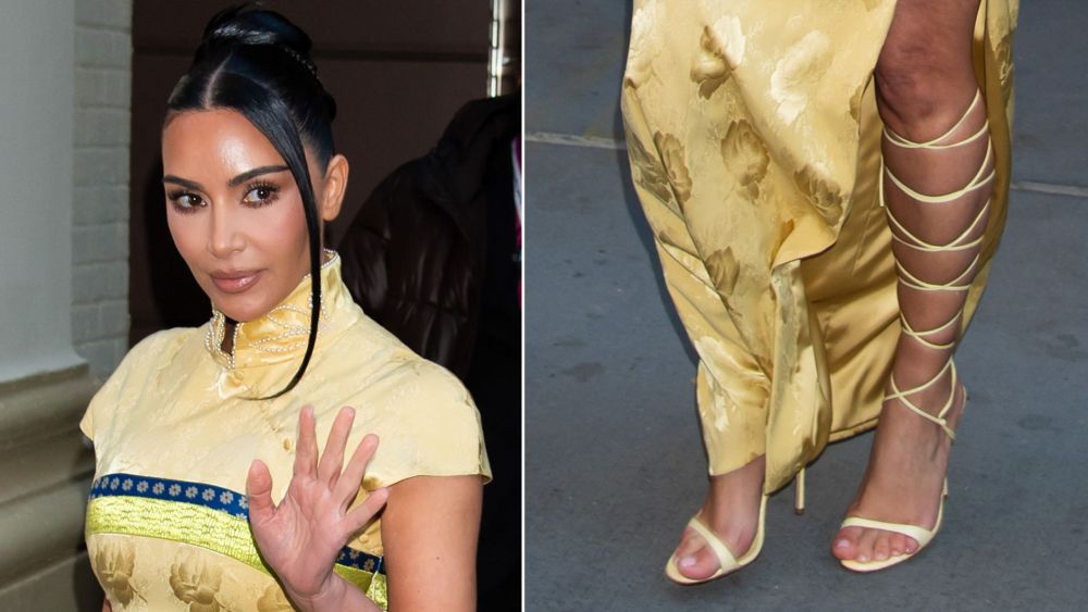 Kim Kardashian wearing a pair of butter yellow gladiator-style heels during a visit to 'The Fear of 13' on Broadway on Sunday.