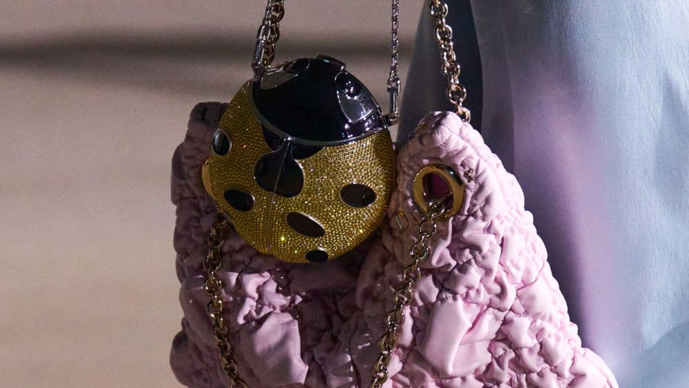 Details of a bag from Dior cruise 2027 featuring a shimmering ladybug accent.