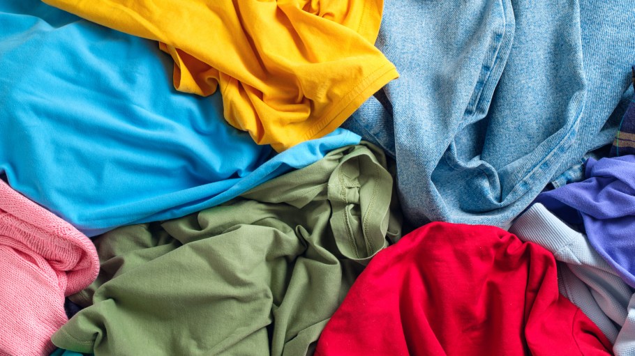 Lots of bright dirty colorful scattered clothes, abstract background. The concept of homework, lack of time for household chores.?