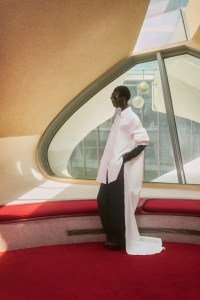 Balenciaga cotton shirt, cotton high-waist pants, calfskin gloves and silk Jet Lag sandal; Chanel sunglasses; Howl 18-karat yellow gold Bittina Tahitian Pearl earrings.