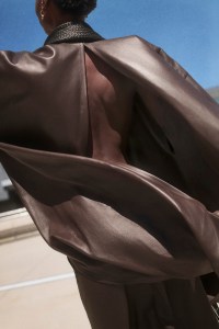 Bottega Veneta lambskin leather top and trousers, and rubber shoes; Cartier 18-karat yellow gold love earrings.